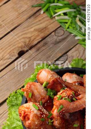 Roasted chicken legs and wings, wooden table . Roasted chicken legs and wings, wooden table . 48297810