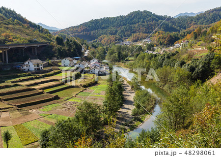 vegetable gardens near village houses near river  48298061