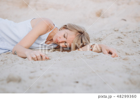 girl sundress lies sand sad crying longing 48299360