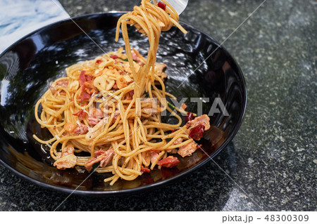 Spicy and chili spaghetti with with bacon in black Spicy and chili spaghetti with with bacon in black 48300309
