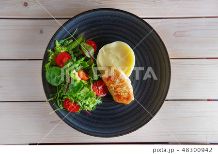 Fried chicken patty with mashed potato and spinach Fried chicken patty with mashed potato and spinach 48300942