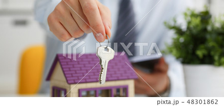 Male hand holds the key to the lock in the hand Male hand holds the key to the lock in the hand 48301862
