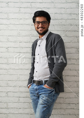 Handsome man posing at brick wall 48302260