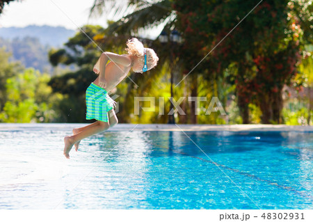 Child in swimming pool. Summer vacation with kids. 48302931