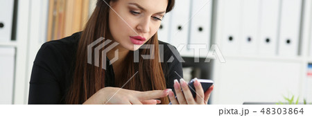 Beautiful brunette smiling businesswoman hold in arm cellphone 48303864
