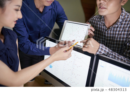 Product managers discussing monthly statistics 48304313