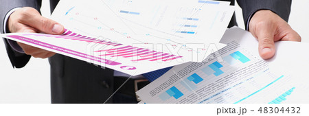 Male hand holding document with graph 48304432