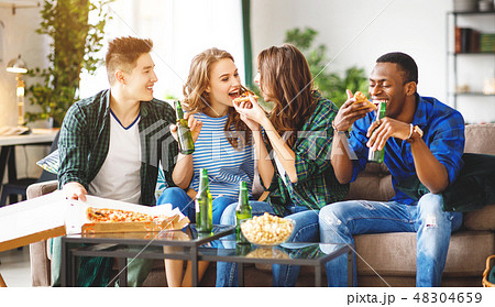 group of happy friends with beer and pizza at home 48304659