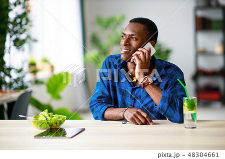 healthy eating. happy young black man eating salad healthy eating. happy young black man eating salad 48304661