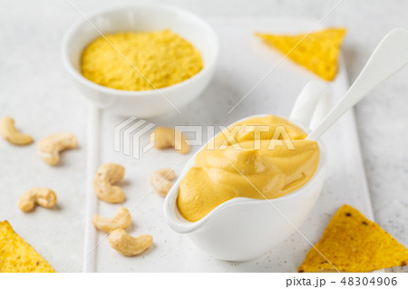 Vegan Cashew Cheese Sauce in white sauceboat Vegan Cashew Cheese Sauce in white sauceboat 48304906