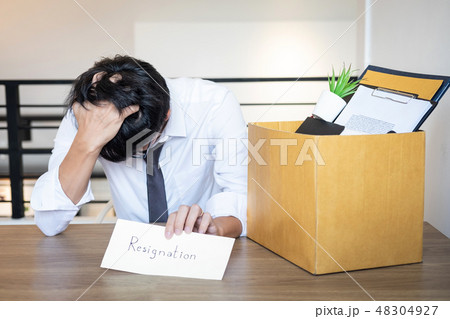 Stressed businessman will being resignation and packing belongin Stressed businessman will being resignation and packing belongin 48304927