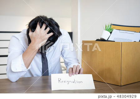 Stressed businessman will being resignation and packing belongin 48304929
