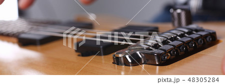 Male arms playing classic shape electric guitar 48305284