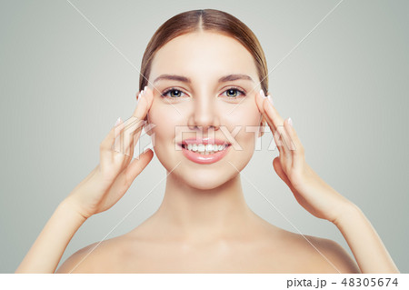 Beautiful woman touching her face in eyes area 48305674