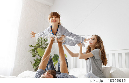 happy family mother, father and child in bed happy family mother, father and child in bed 48306016