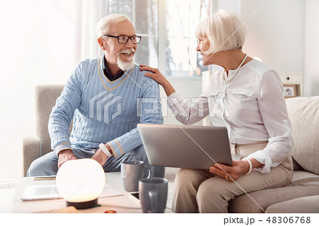 Upbeat couple discussing recent news having read them online Upbeat couple discussing recent news having read them online 48306768