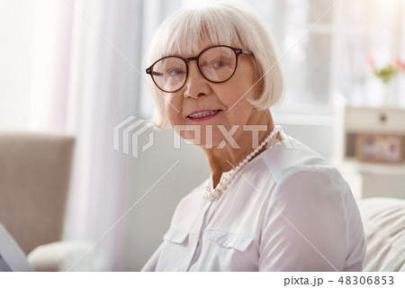 Close up of cheerful elderly woman in eyeglasses smiling 48306853