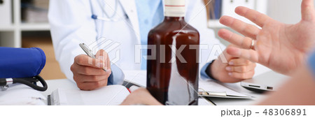Alcoholic hold in arm empty bottle at doctor Alcoholic hold in arm empty bottle at doctor 48306891