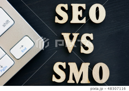 SEO vs SMO and keyboard on a dark desk. SEO vs SMO and keyboard on a dark desk. 48307116