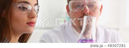 Technician hold in arms in protective gloves sample bottle Technician hold in arms in protective gloves sample bottle 48307281