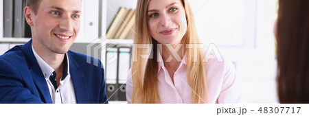 Smiling man and woman shake hands Smiling man and woman shake hands 48307717