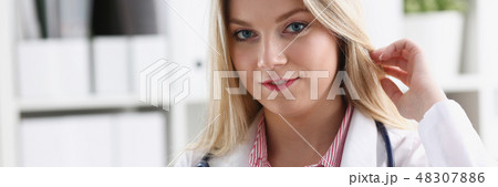 Beautiful smiling female doctor sit at workplace Beautiful smiling female doctor sit at workplace 48307886