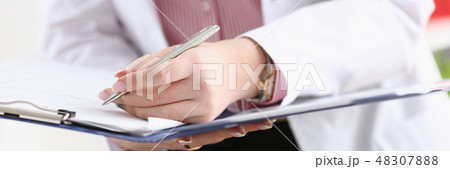 Male doctor arm hold silver pen filling patient 48307888