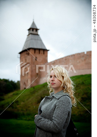 Tower of old castle fortification, young blonde woman 48308734