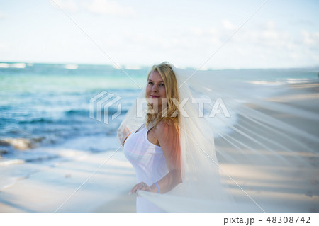 Young sexy blonde woman in white dress and bridal veil 48308742