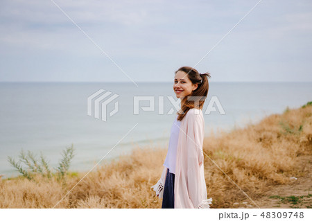 Young pretty girl posing on camera and enjoying summer day. Young pretty girl posing on camera and enjoying summer day. 48309748