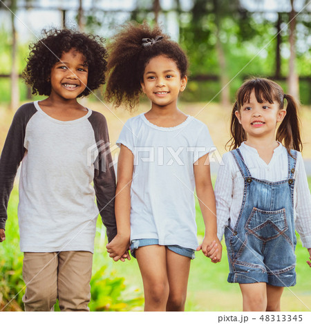 Happy kids group playing in the park in school. 48313345