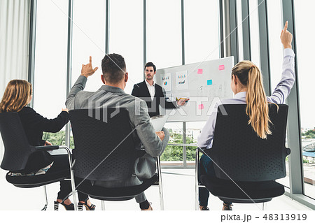 Businesswomen and businessmen in group meeting. 48313919