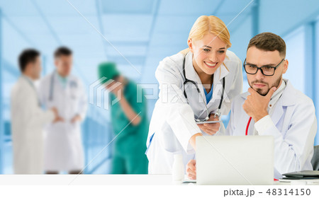 Doctor working in hospital with other doctors. Doctor working in hospital with other doctors. 48314150