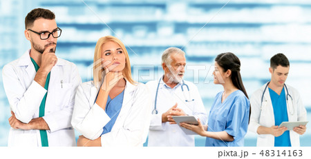 Doctor working in hospital with other doctors. 48314163