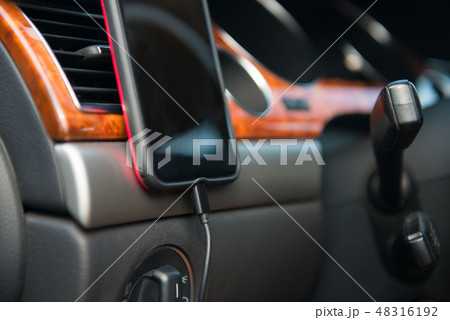 Car A/C magnet mobile phone holder in use 48316192