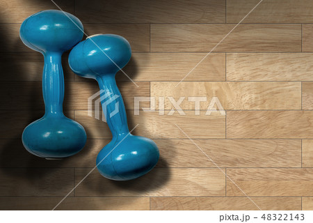 Blue dumbbells on the gym floor - Weight training Blue dumbbells on the gym floor - Weight training 48322143