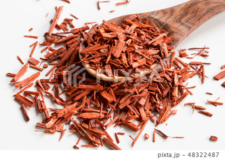 Sandalwood on a wooden spoon on a white table 48322487