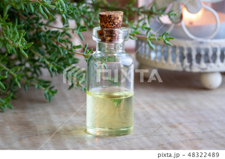 A bottle of thyme essential oil with fresh thyme 48322489