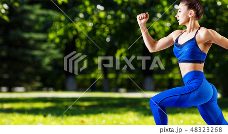 Sporty young woman jogging outdoors in the summer. Sporty young woman jogging outdoors in the summer. 48323268