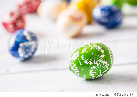 Close-up multicolored easter eggs on wooden table Close-up multicolored easter eggs on wooden table 48325847