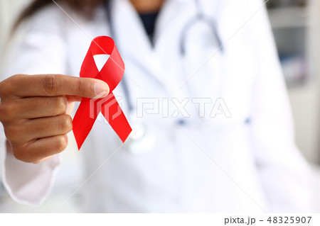 Black woman doctor holding a red ribbon 48325907