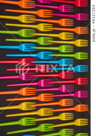Many color plastic forks on a bright background Many color plastic forks on a bright background 48327263