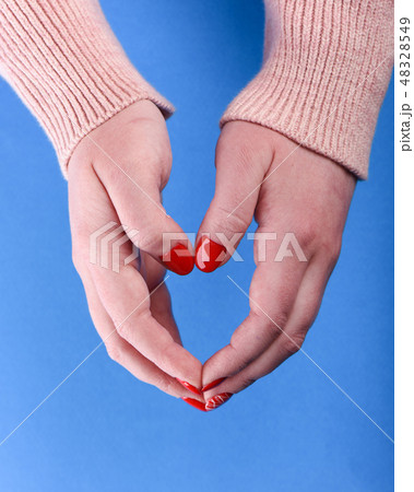 Hands of a girl in a beige sweater 48328549
