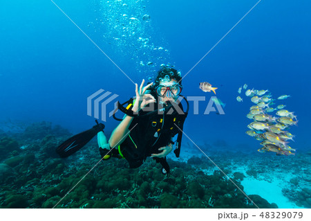 Young woman scuba diver showing OK gesture. 48329079