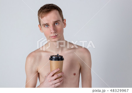Naked handsome guy drink from coffee or tea cup 48329967