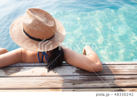 Asian woman relaxing in swimming pool, Travel 48330242