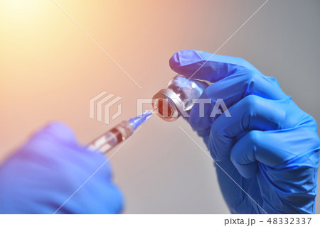 Closeup of vaccine bottle with syringe and needle Closeup of vaccine bottle with syringe and needle 48332337