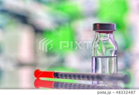 Closeup of vaccine bottle with syringe and needle Closeup of vaccine bottle with syringe and needle 48332487