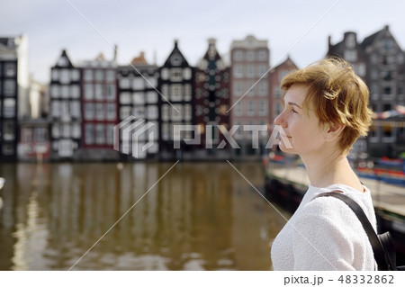 Woman looking on dancing houses of Amsterdam 48332862