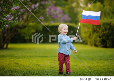 Little boy holding russian flag during walking 48333052